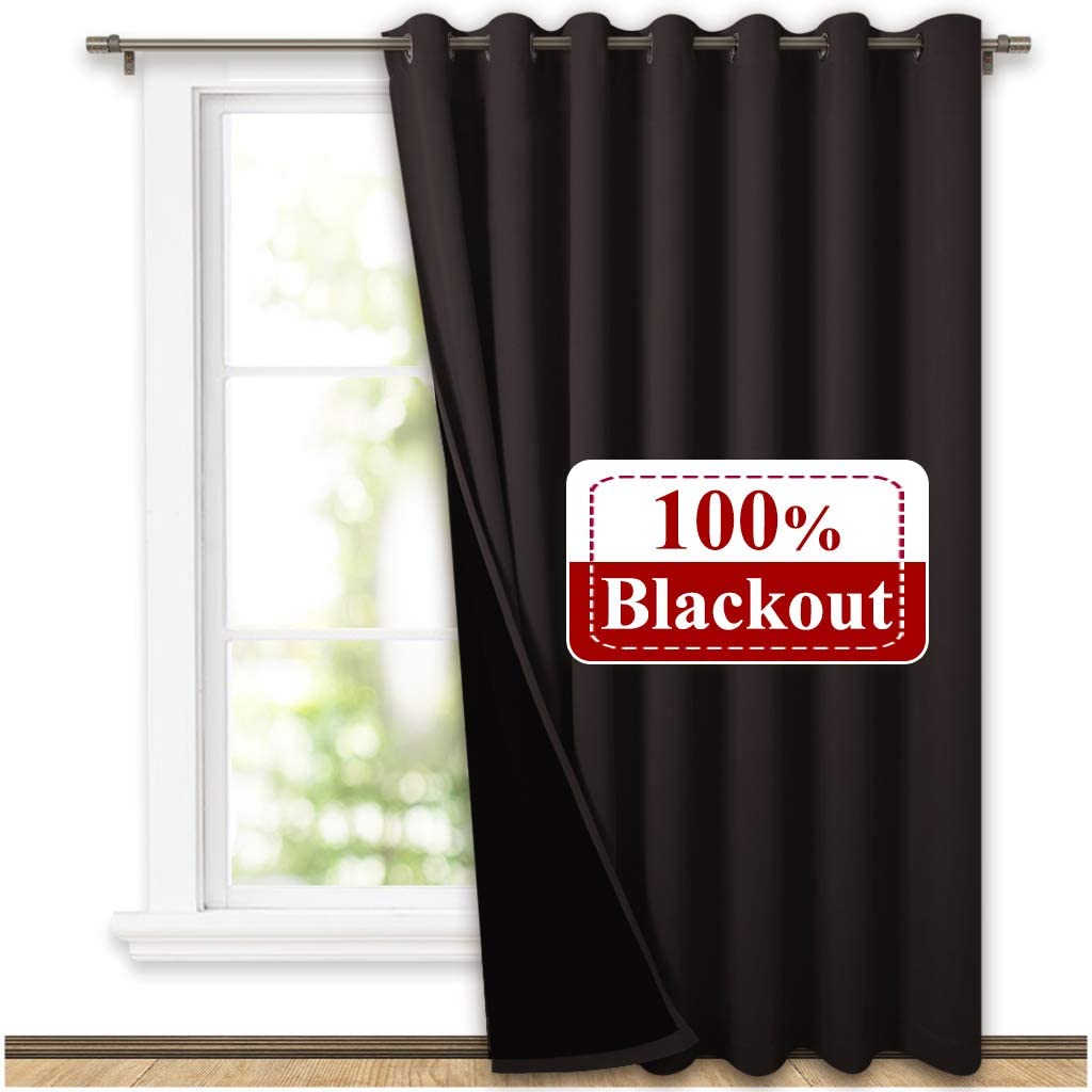 Dark brown double layer thermal insulated grommet blackout curtain panel, partly covering a window, demonstrating 100% light blocking.