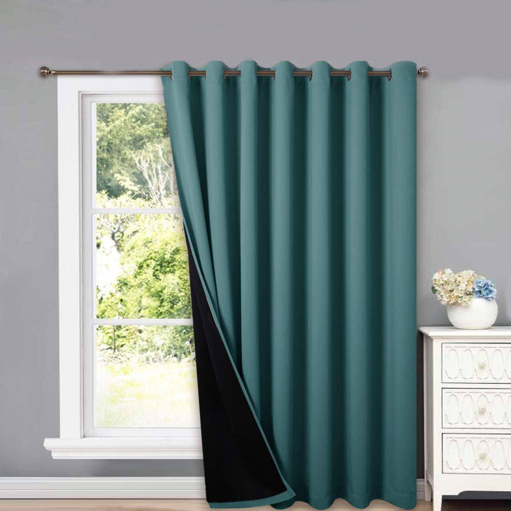 Teal double-layer grommet thermal insulated blackout curtain panel with black lining open at a living room window.