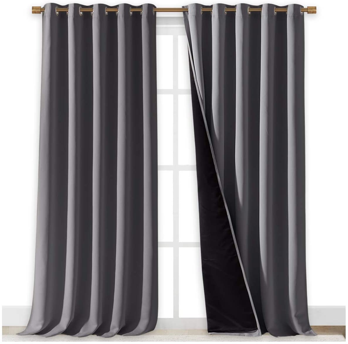 Two dark grey double layer noise reducing living room curtains with silver grommets on a gold rod, one panel reveals black lining.