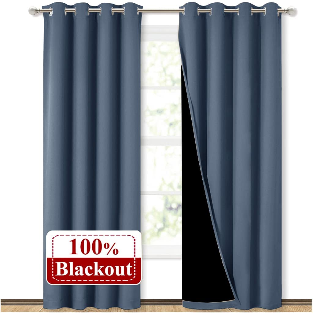 Two double layer slate blue noise reducing living room curtains with silver grommets, one showing the 100% blackout lining.
