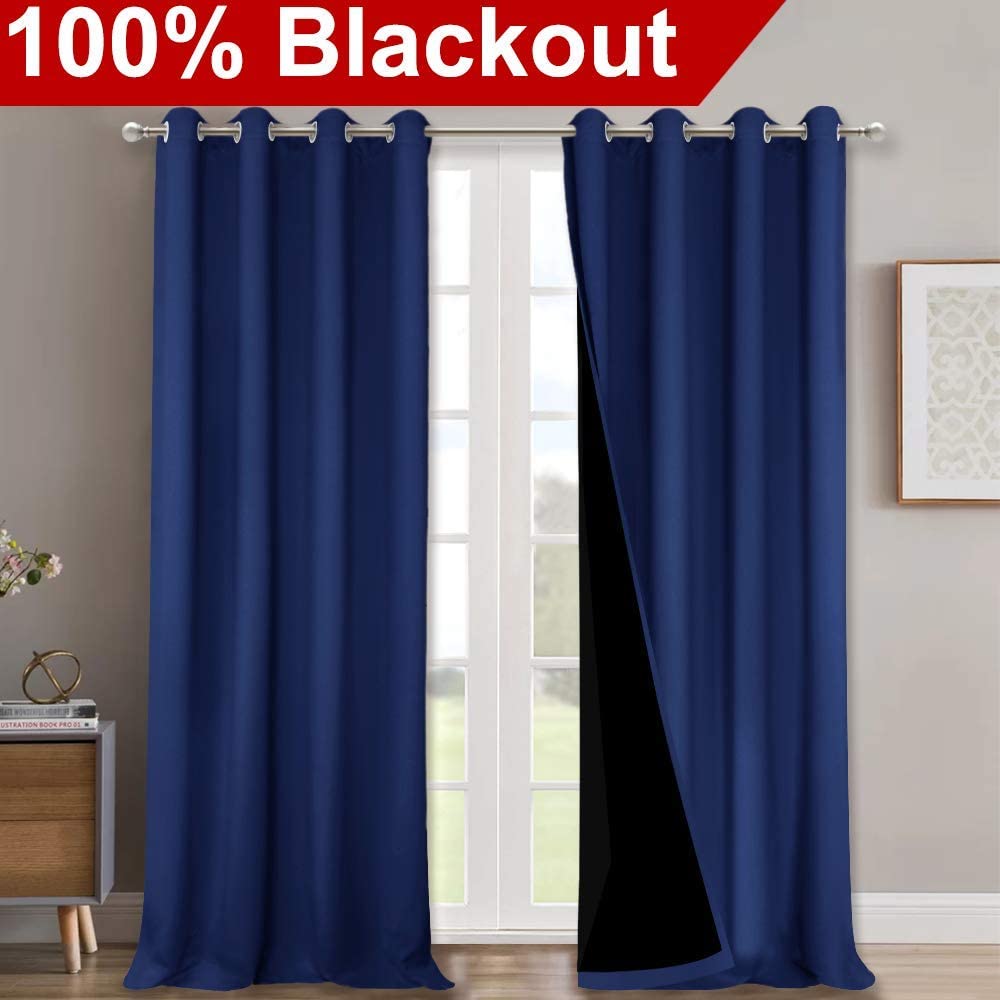 Two navy blue double layer 100% blackout curtains with silver grommets for a living room, revealing the noise reducing black lining.