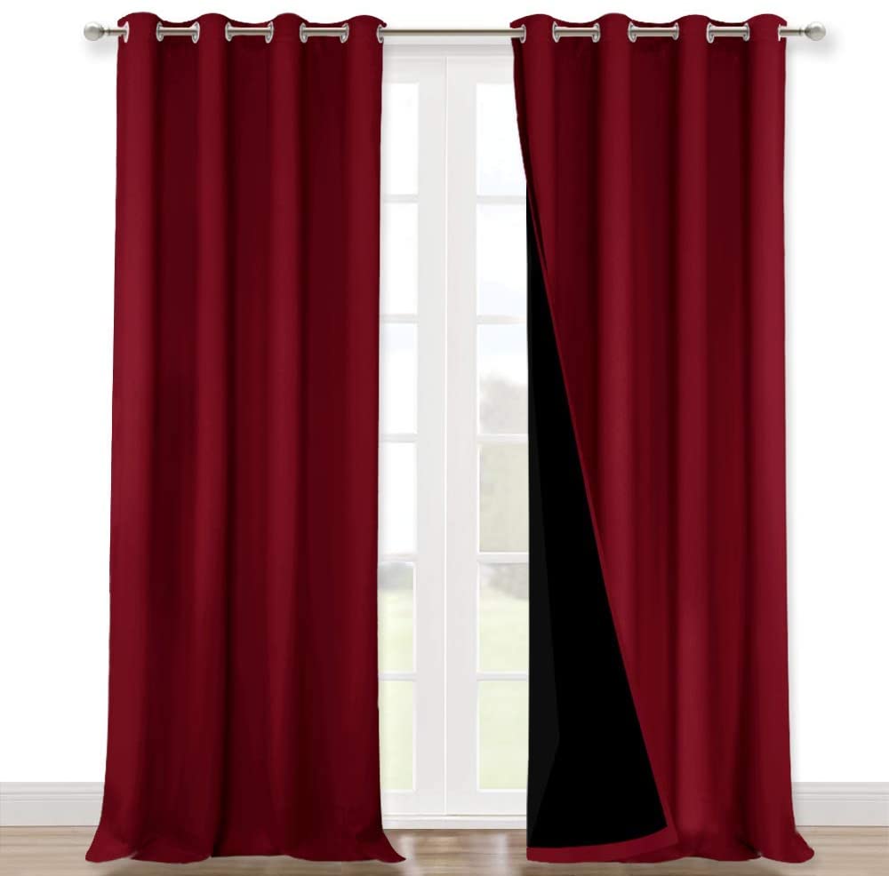 Red double layer noise reducing living room curtains, 2 panels with silver grommets, revealing the black blackout lining.