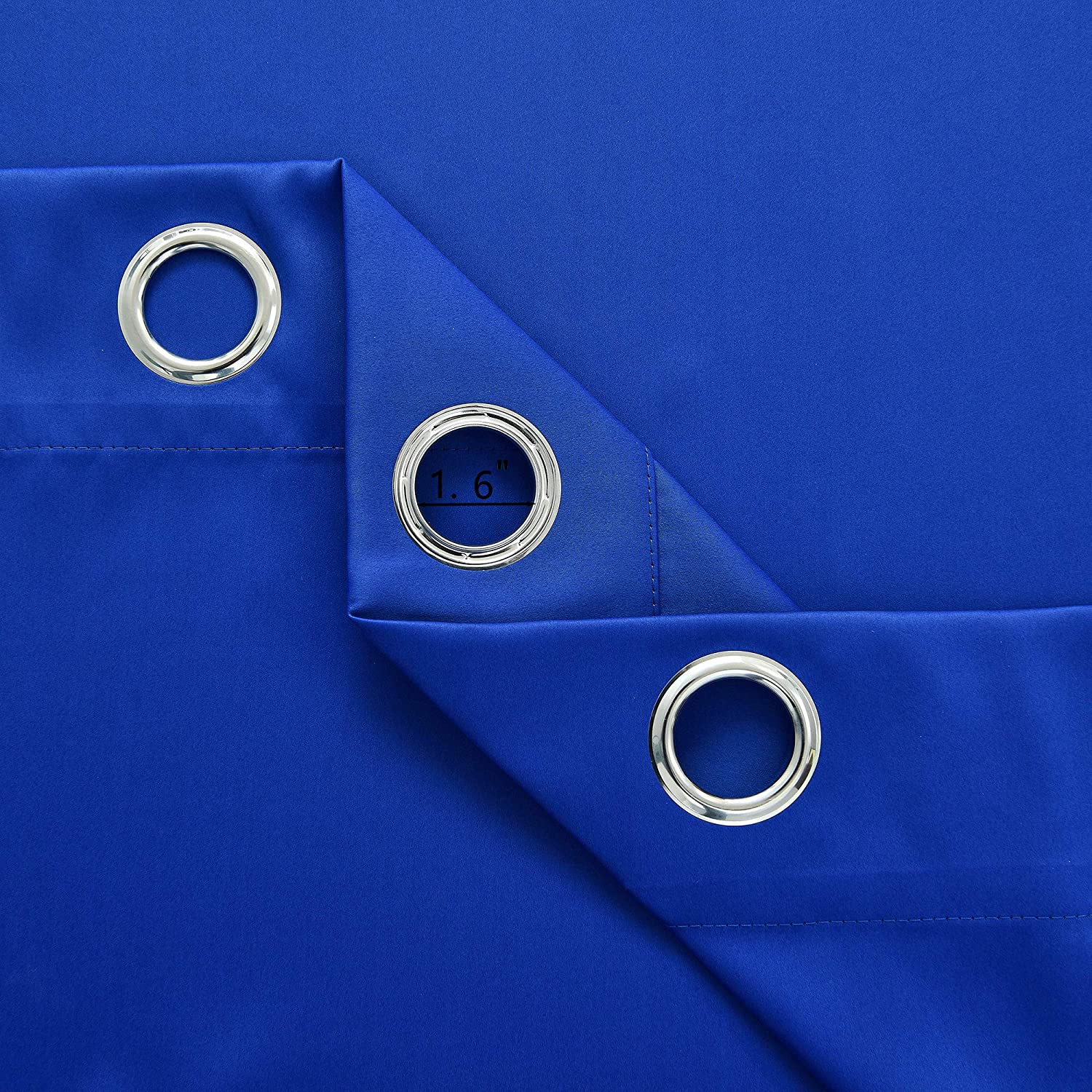 Close-up of royal blue grommet blackout thermal insulated curtain fabric, showing three silver grommets with 1.6" measurement