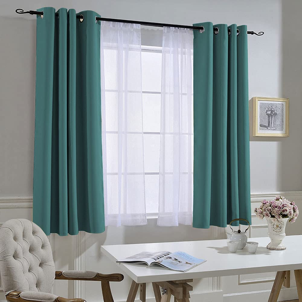 Teal grommet noise reducing blackout curtains (2 panels) layered with white sheers in a stylish living room or bedroom.