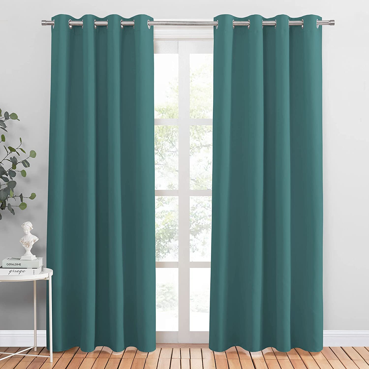 Dark teal grommet blackout curtains (2 panels) on a silver rod, perfect for noise reduction in living rooms or bedrooms.