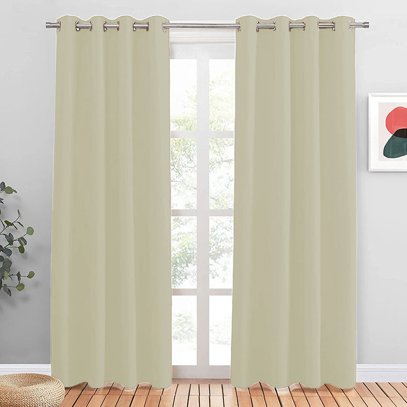 Cream grommet noise reducing blackout curtains (2 panels) on a silver rod, covering a window for living room or bedroom privacy.