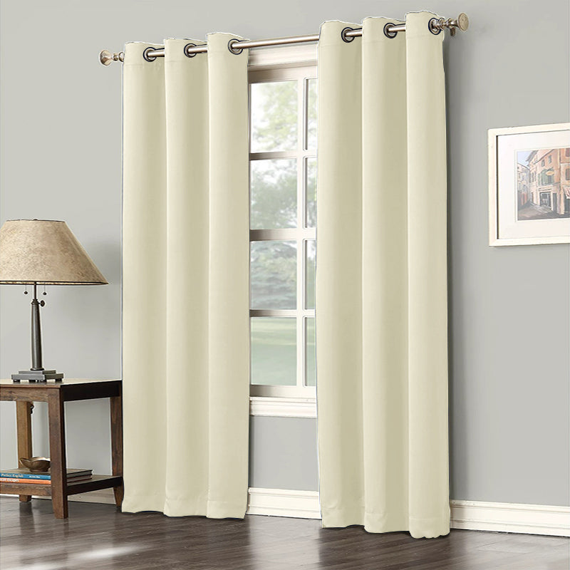Cream blackout grommet curtains (2 panels) for living room or bedroom, offering noise reduction and privacy on a window.