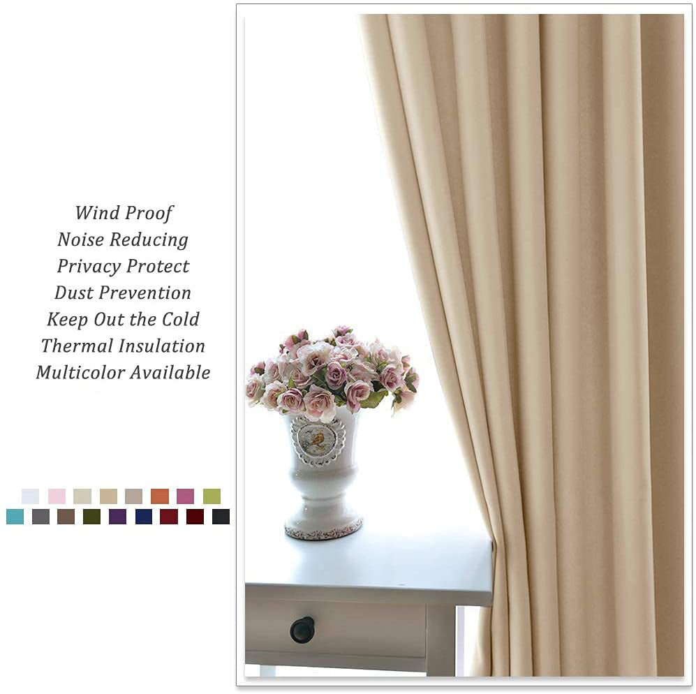 Khaki beige grommet blackout curtain in a living room, partially open, beside a white table with a vase of pink flowers.