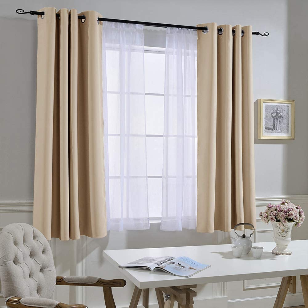 Two beige grommet noise reducing blackout curtain panels with sheer white curtains, ideal for living room or bedroom window.