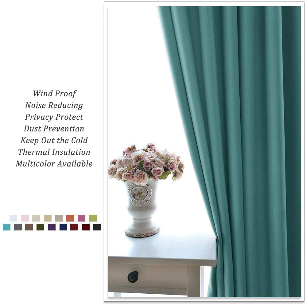 Teal grommet noise reducing blackout curtain offering thermal insulation, next to a window with a decorative vase.