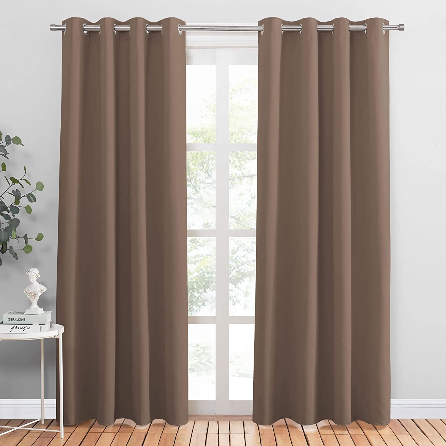 Two brown grommet noise reducing blackout curtains covering a window, suitable for living room or bedroom.