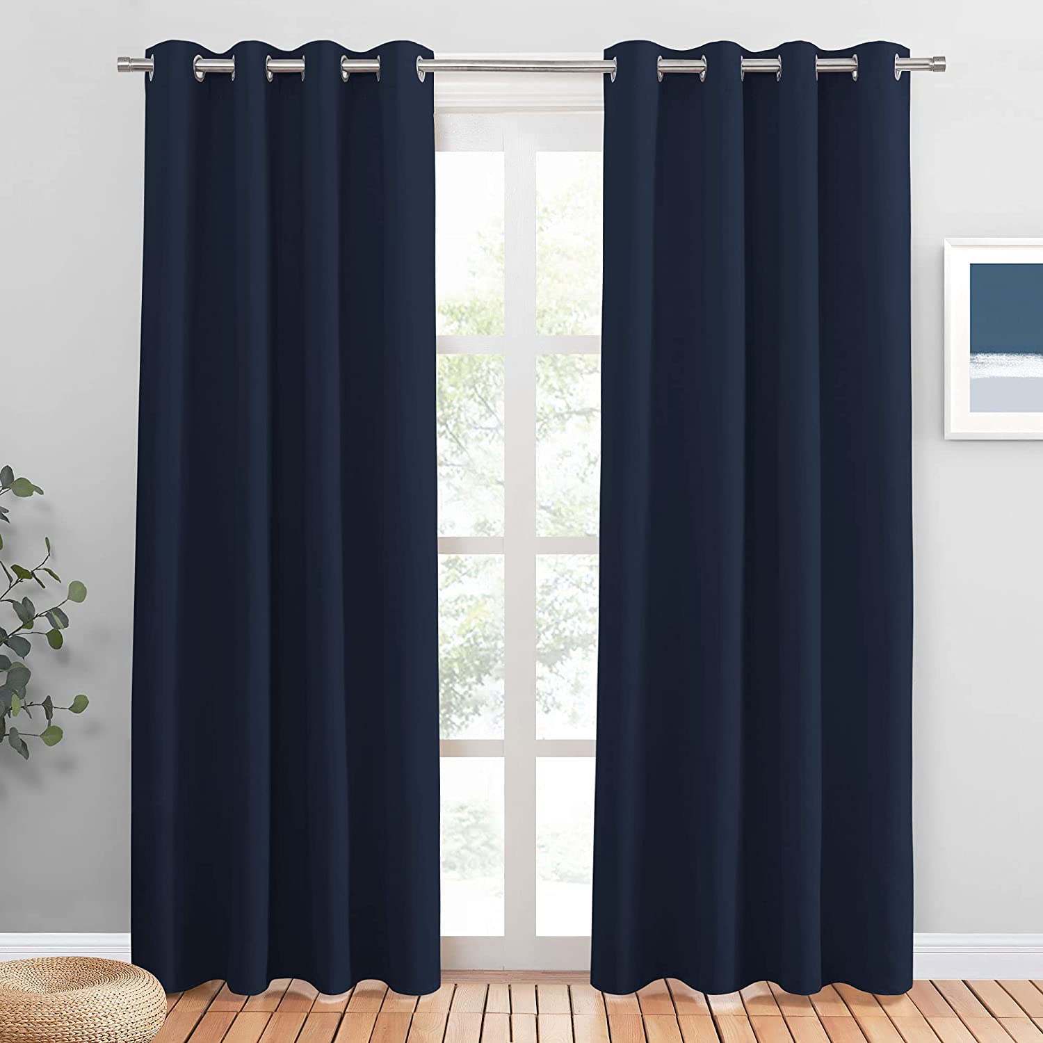 Two navy blue blackout grommet curtains (2 panels) on a window, ideal for living room & bedroom noise reduction.