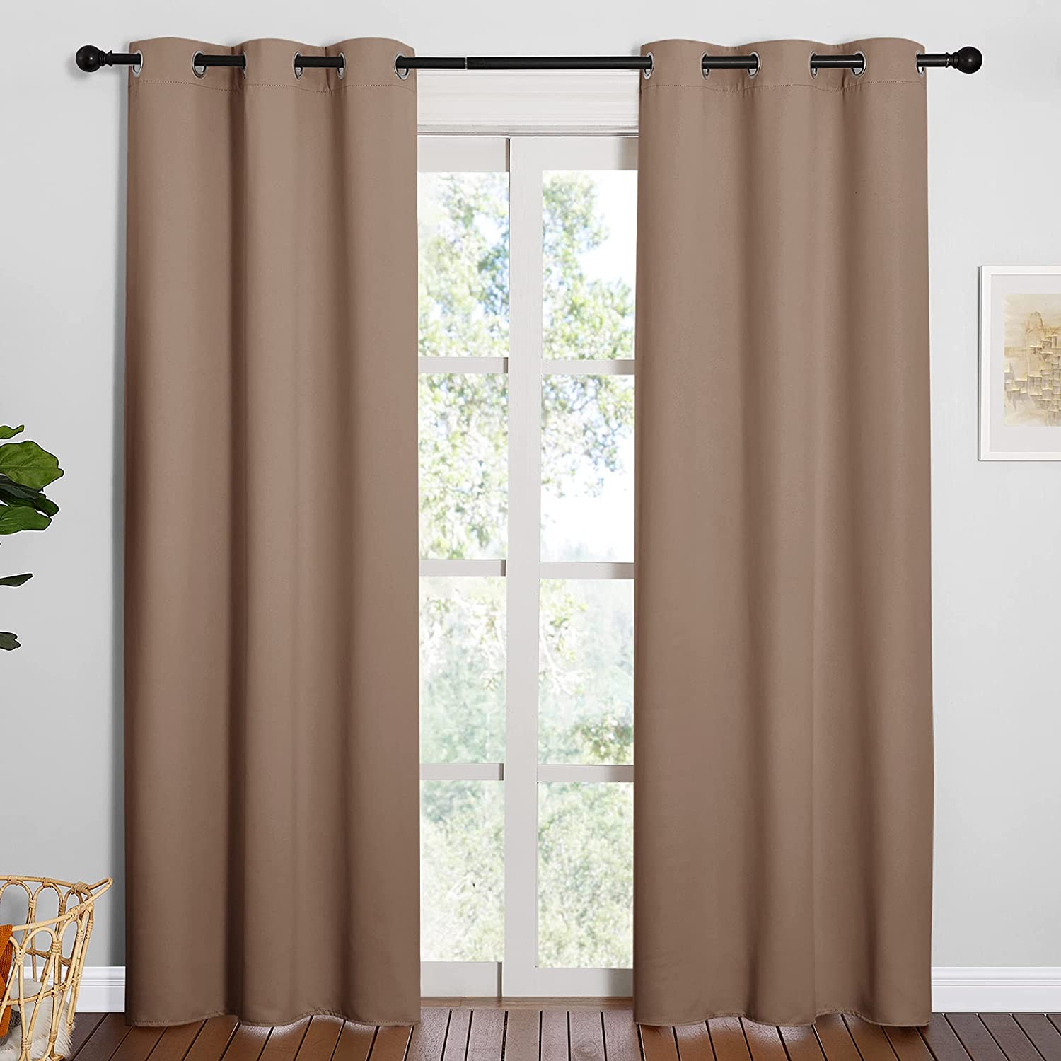 Brown solid 2-panel blackout curtains with silver grommets on a window, providing thermal insulation & privacy for living rooms.