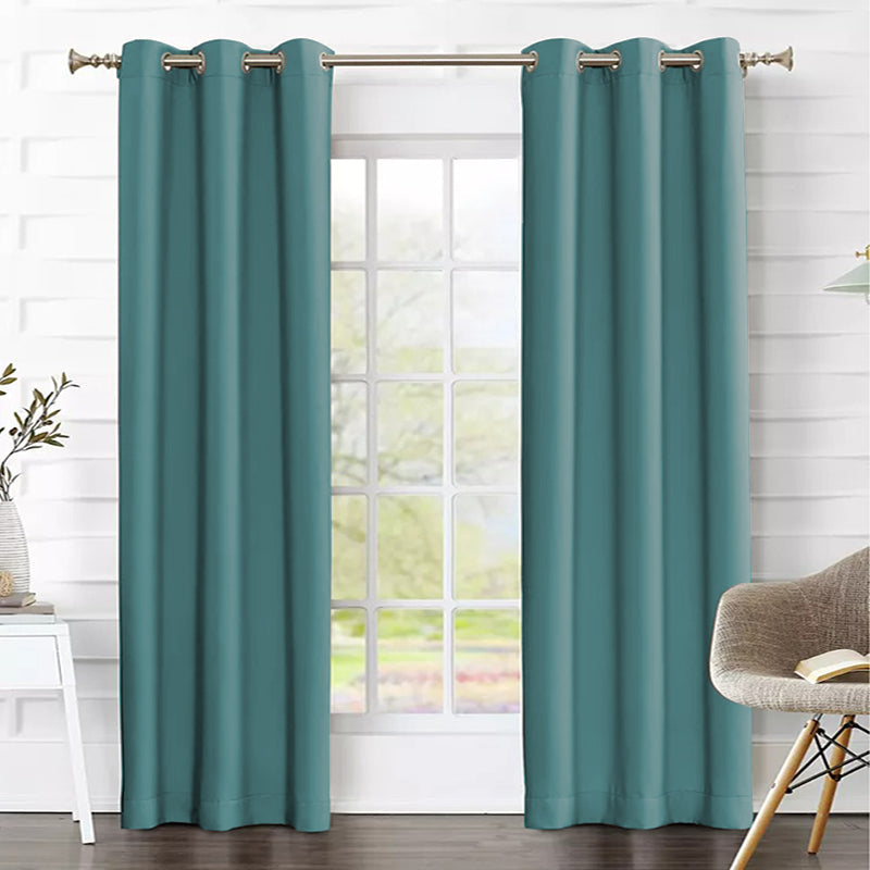 Two teal grommet thermal insulated blackout curtains in a living room, enhancing privacy and light control for the window.