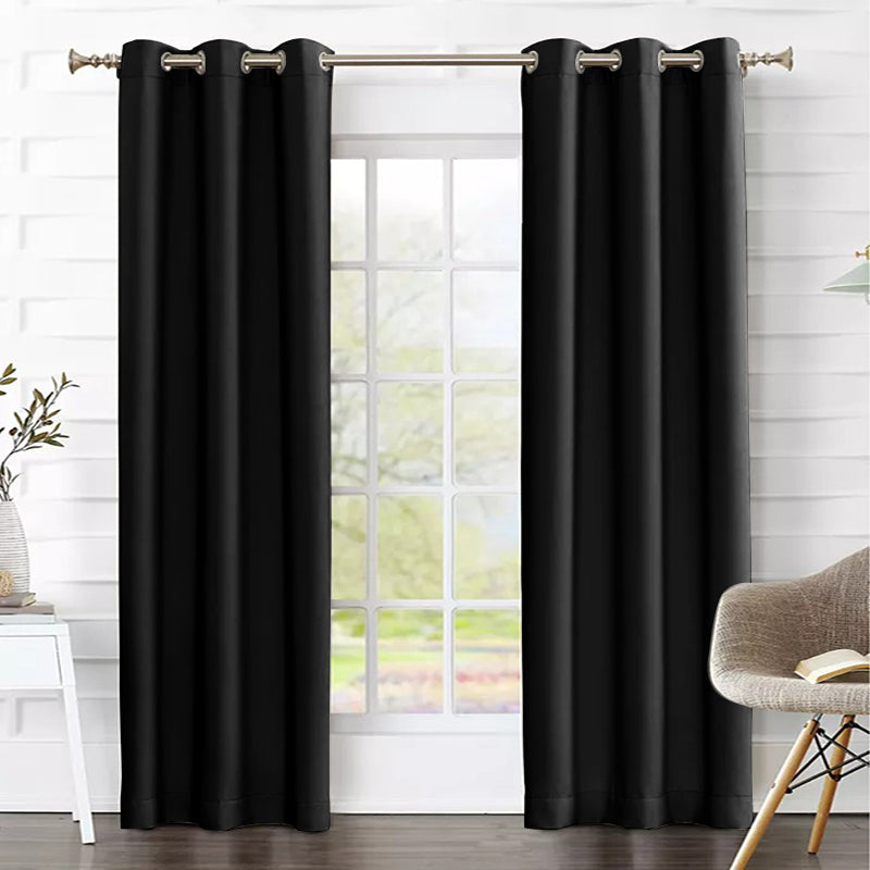 Two black grommet thermal insulated blackout weave curtains covering a living room window, enhancing privacy and light control.