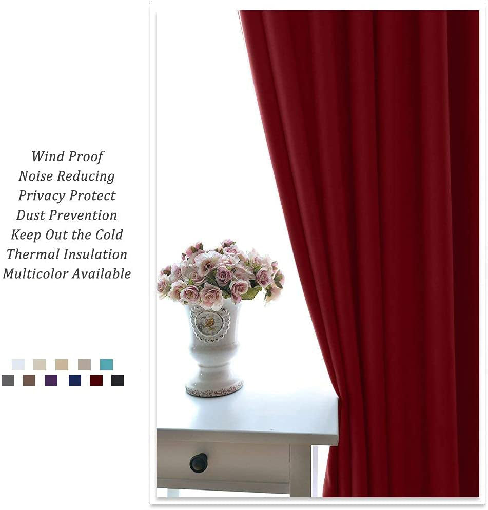 Deep red thermal insulated blackout curtain panel drapes by a living room window, offering privacy and light control.