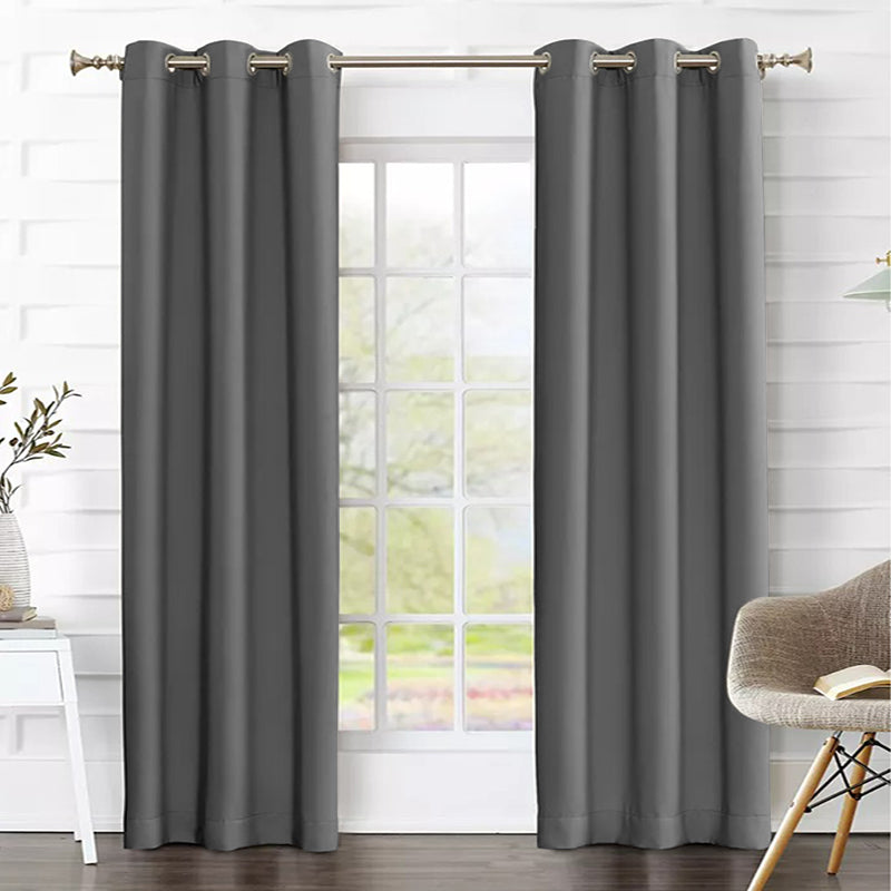 Two charcoal grommet thermal insulated blackout weave curtain panels framing a bright living room window.