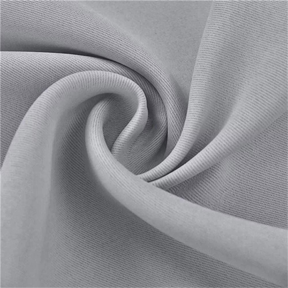 Detailed close-up of textured light gray 3-layer fabric for thermal soundproof blackout curtains