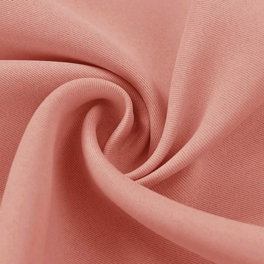 Soft pink 3-layer thermal soundproof blackout curtain fabric, showing its tight weave, texture, and elegant drape.