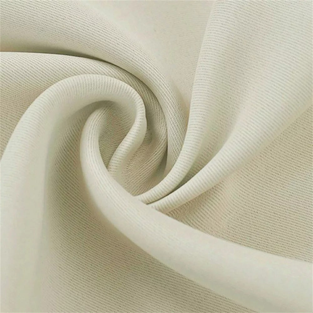 Close-up of cream 3-layer thermal soundproof blackout curtain fabric, showing its subtle texture and elegant drape