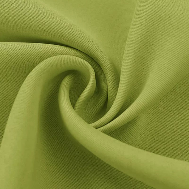 Close-up of vibrant green 3-layer thermal soundproof blackout curtain fabric, showcasing its soft folds and dense texture.