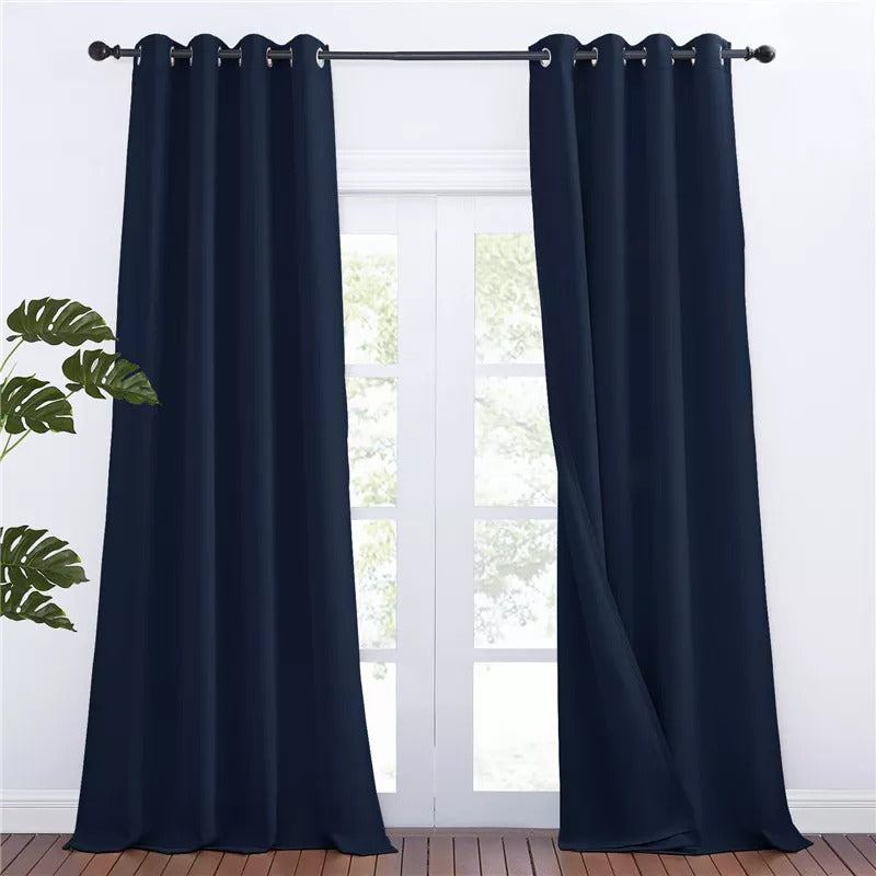 Dark blue grommet blackout curtains, 2 panels, hung over glass doors. Ideal for living room or bedroom thermal & soundproofing.