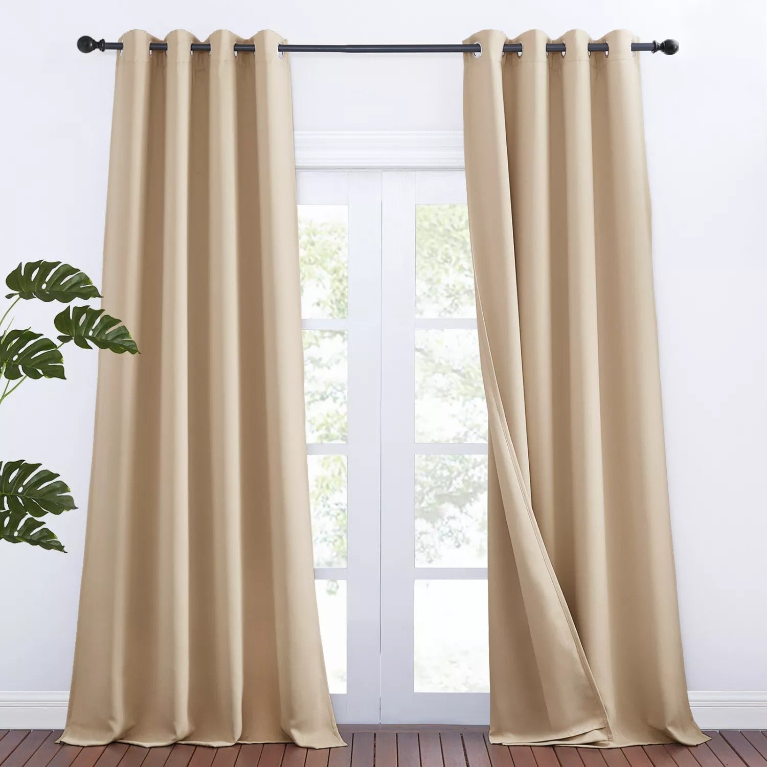 Two beige grommet 3-layer thermal soundproof blackout curtain panels, shown partially open, perfect for living room or bedroom.