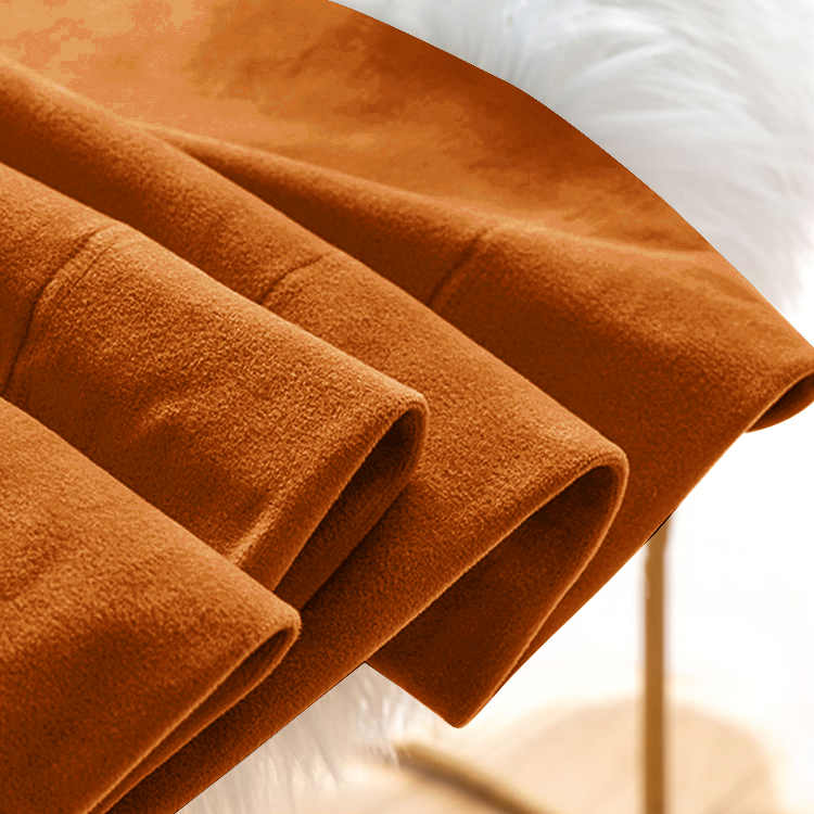 Close-up of deep orange-brown velvet blackout curtain fabric, showcasing its plush texture and elegant folds for living room or bedroom.