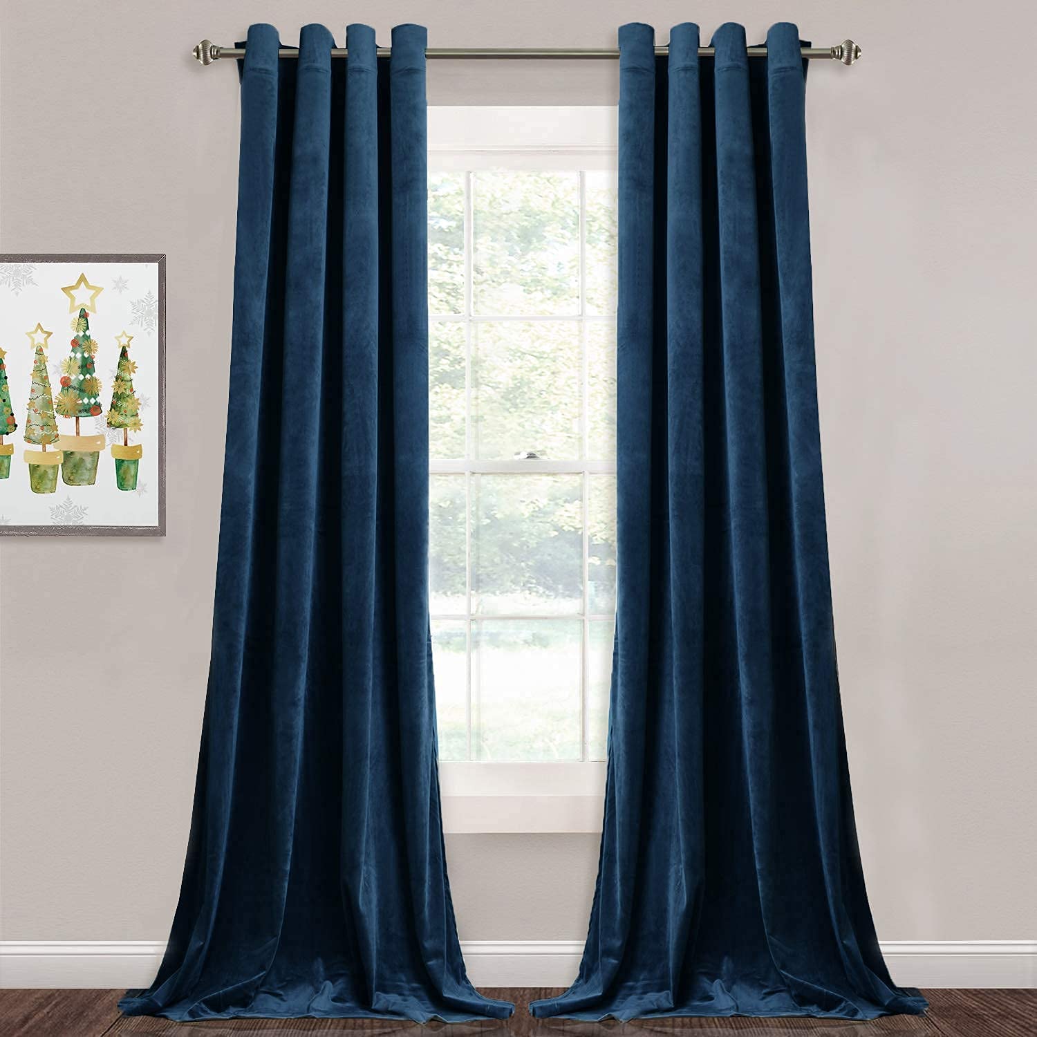 Two dark blue velvet grommet blackout curtain panels, fully drawn over a window, pooling on the floor for bedroom and living room privacy.