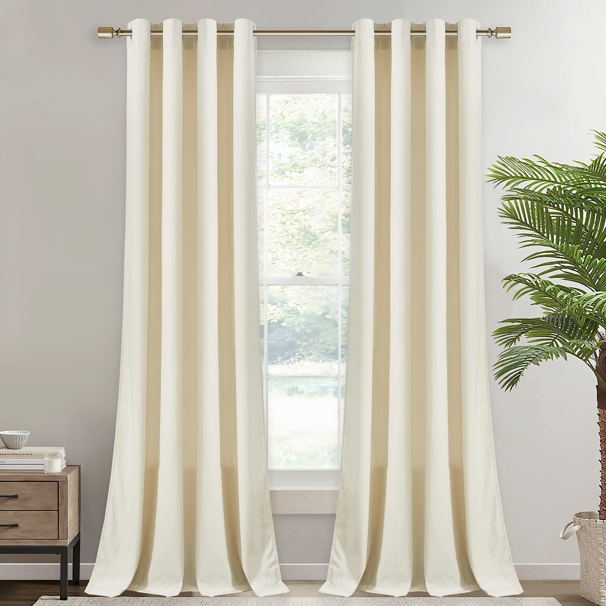 Elegant cream velvet grommet blackout curtains, 2 panels, on a gold rod, partially open for bedroom & living room privacy.