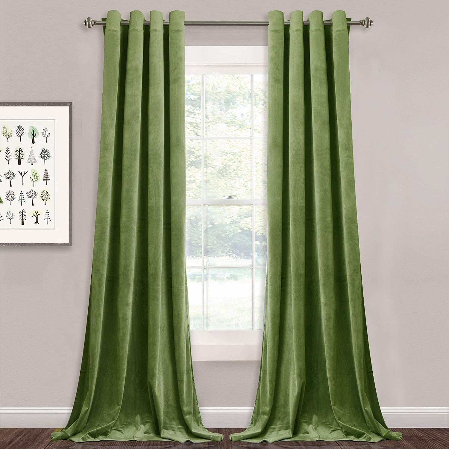 Two green velvet grommet blackout curtains for bedroom/living room, hanging over a window, pooling on dark wood floor.