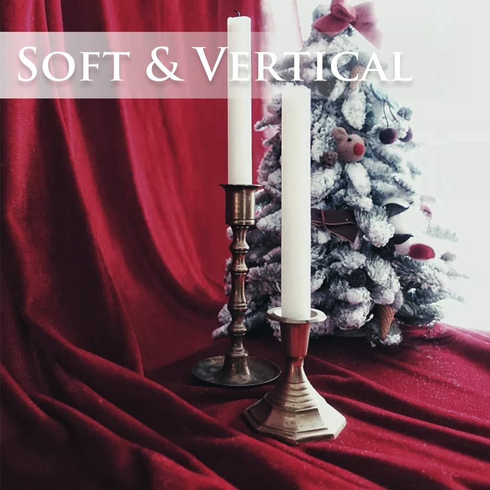 Soft, draped red velvet privacy blackout curtain fabric for bedroom & living room, accented by elegant candles and a frosted tree.