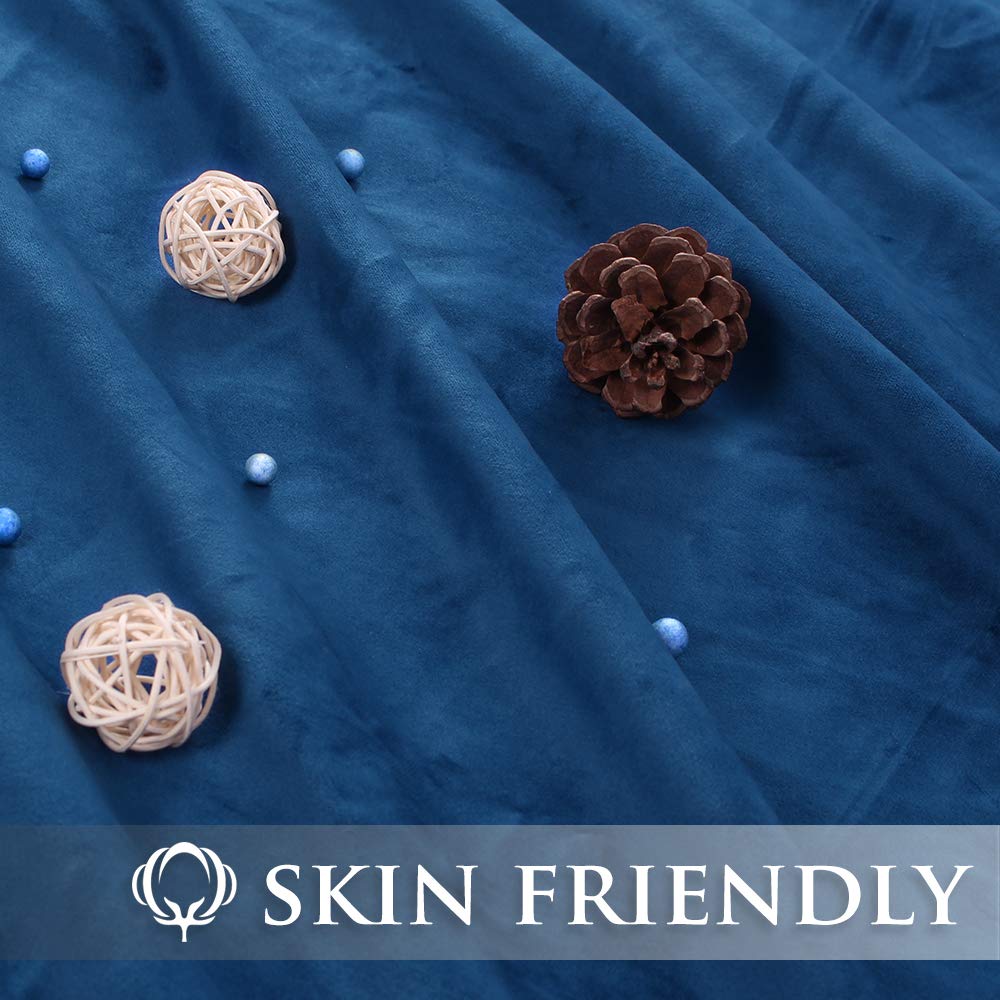 Close-up of skin-friendly, plush blue velvet blackout curtain fabric for bedroom & living room privacy.