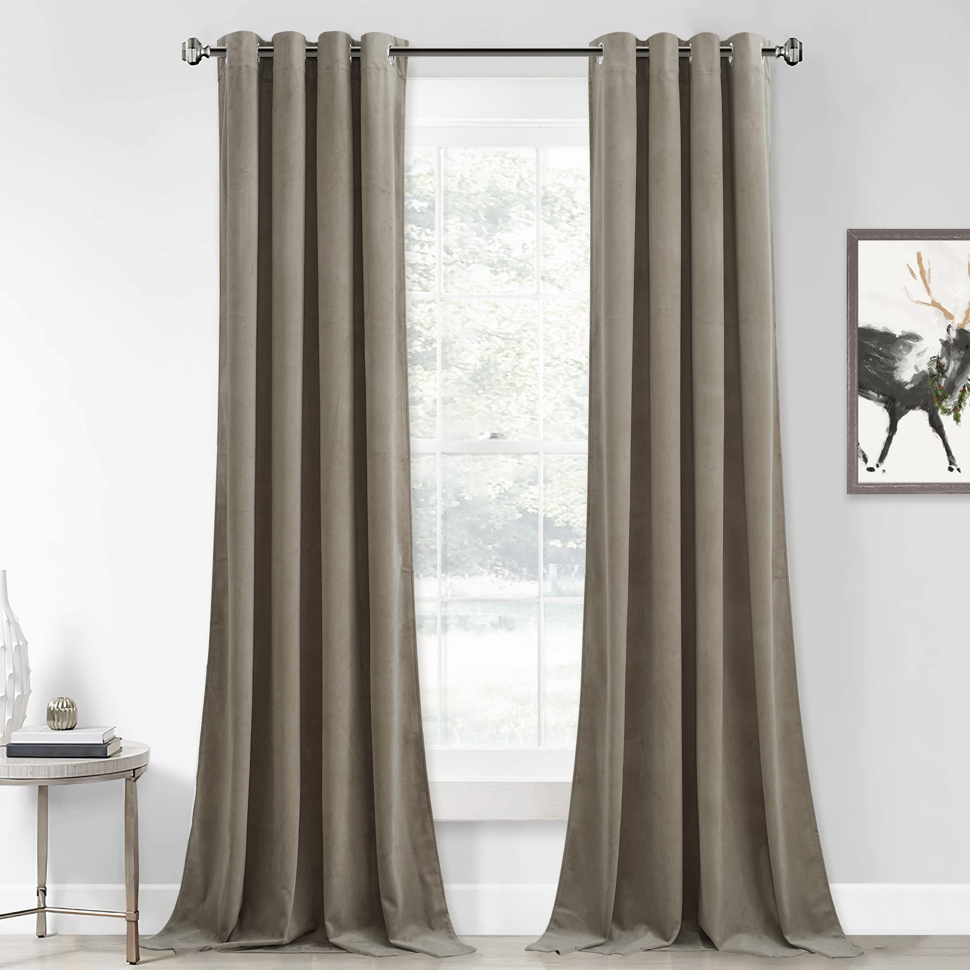 Two gray grommet velvet blackout curtain panels hung over a window, offering privacy and light control for a bedroom or living room.