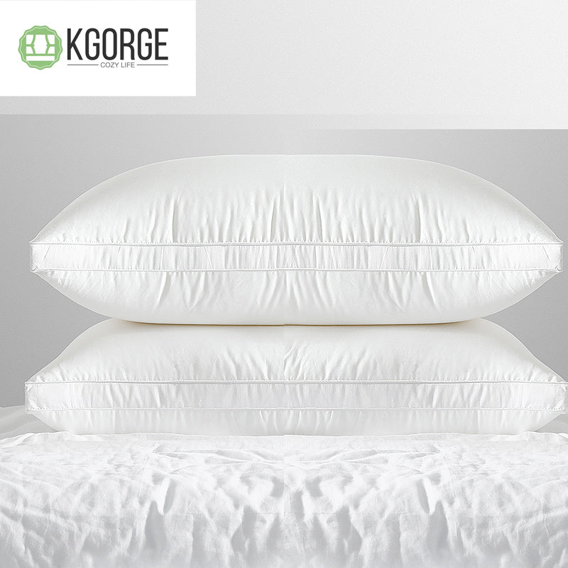 Two KGORGE COZY LIFE white bedroom pillows, stacked neatly on white sheets, showcasing detailed stitching.