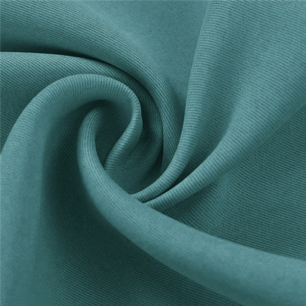 Dark teal blackout outdoor curtain fabric sample, highlighting its soft, dense weave and rich texture in natural drapes.