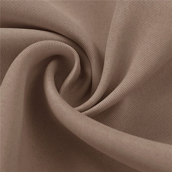 KGORGE beige blackout outdoor curtain fabric sample, highlighting its dense weave for privacy and shade, with soft folds.