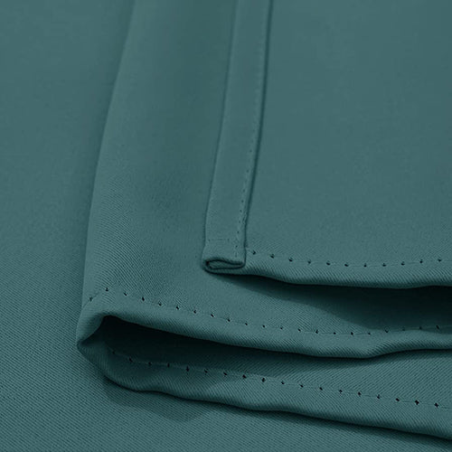 Close-up of a teal outdoor standard curtain sample showing the Fadenomore™ weatherproof fabric texture and quality stitching.
