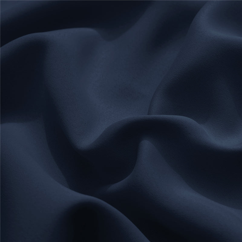 Deep blue KGORGE outdoor curtain fabric sample, highlighting weatherproof material with subtle textured weave and flowing drapes.