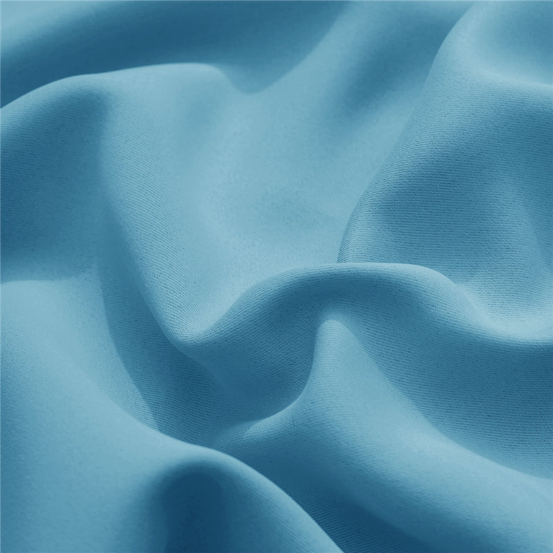 Close-up of a soft light blue KGORGE outdoor curtain fabric sample, emphasizing its durable, weatherproof texture and color.