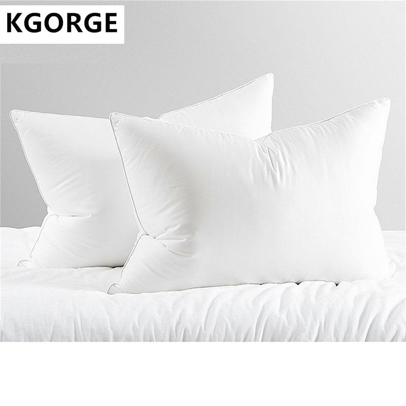 Two KGORGE white soft pillows, plush and inviting, displayed on a bed with white linens for bedroom comfort.