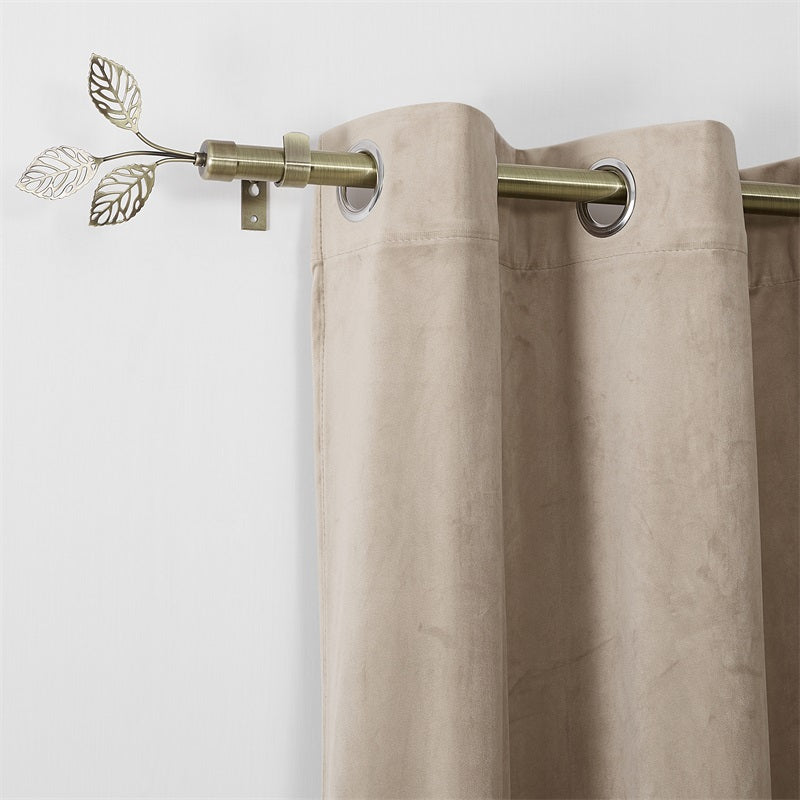 Close-up of Leaf Metallo adjustable outdoor curtain rod in bronze with leaf finials, holding a beige grommet curtain.