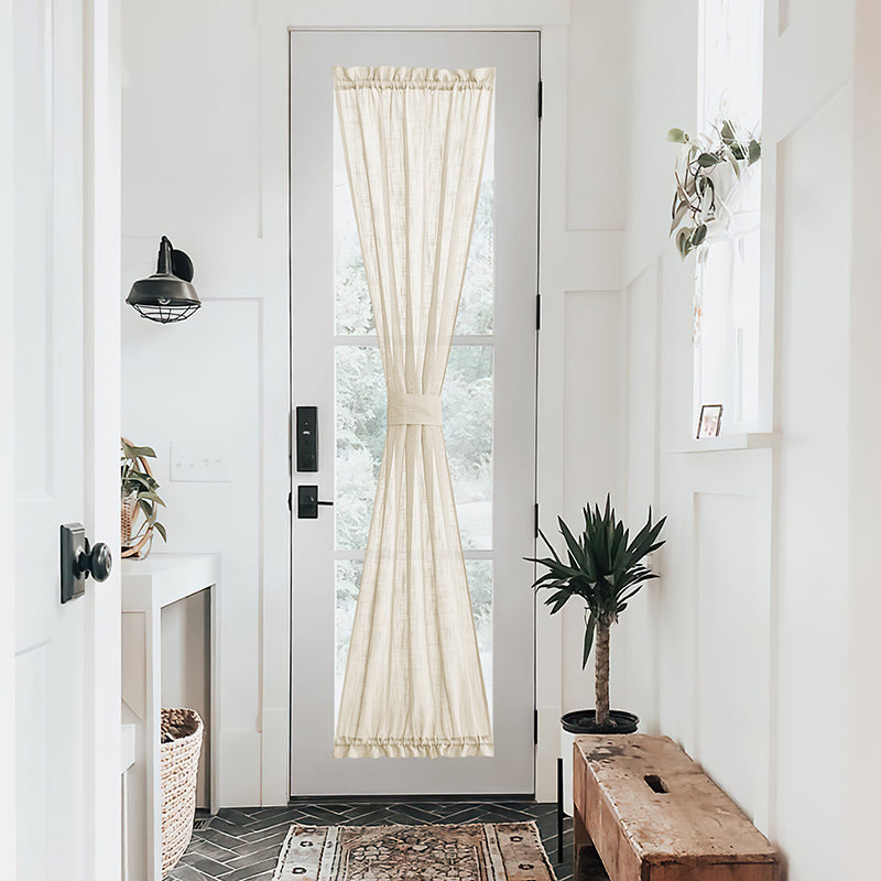 Light filtering semi-sheer linen curtain covering a white French door, tied back in a bright, modern entryway.