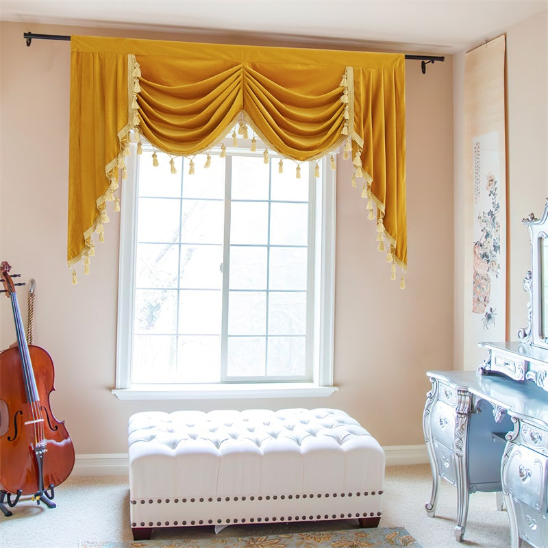 Modern luxury rod pocket golden velvet waterfall valance, showcasing elegant swags & tassels on a living room window.