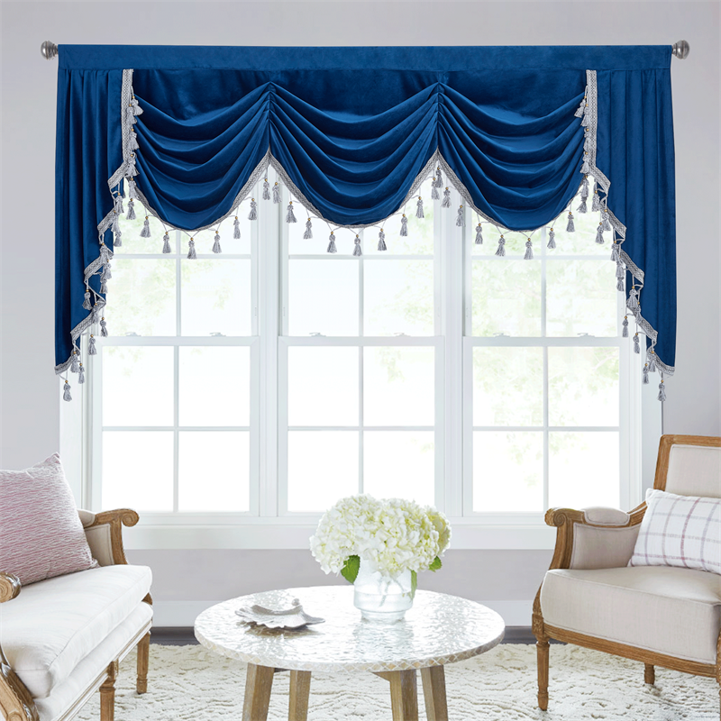 Luxurious blue velvet blackout rod pocket valance with waterfall swag design & decorative tassels for living room windows.
