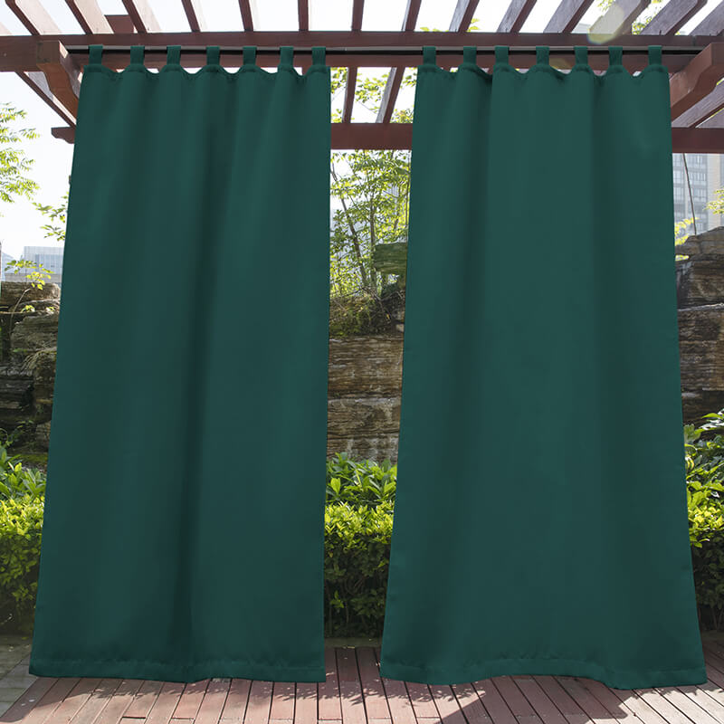 Waterproof emerald tab top outdoor curtains on a wooden pergola, offering shade and privacy for a porch deck.