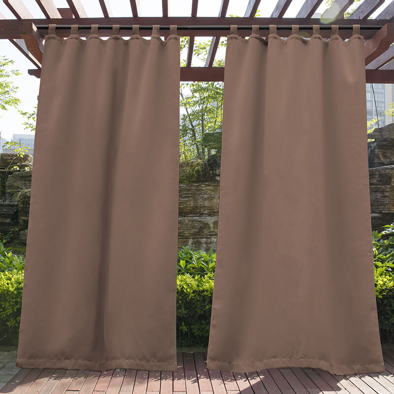 Coffee brown waterproof tab top outdoor curtain panels hanging from a wooden pergola on a porch deck, enhancing privacy.