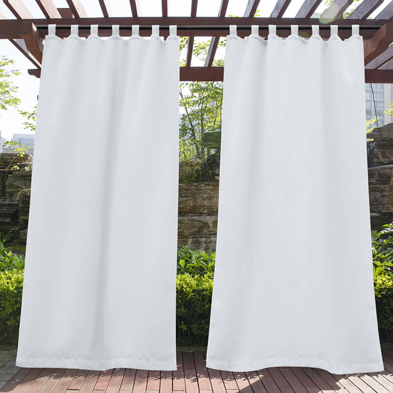 White waterproof tab top outdoor curtains on a pergola, creating privacy and shade for a sunny porch or deck.