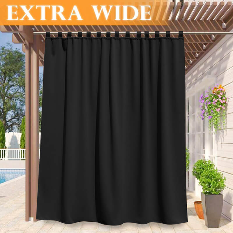 Extra wide black waterproof tab top outdoor curtain providing privacy and shade on a porch deck pergola.