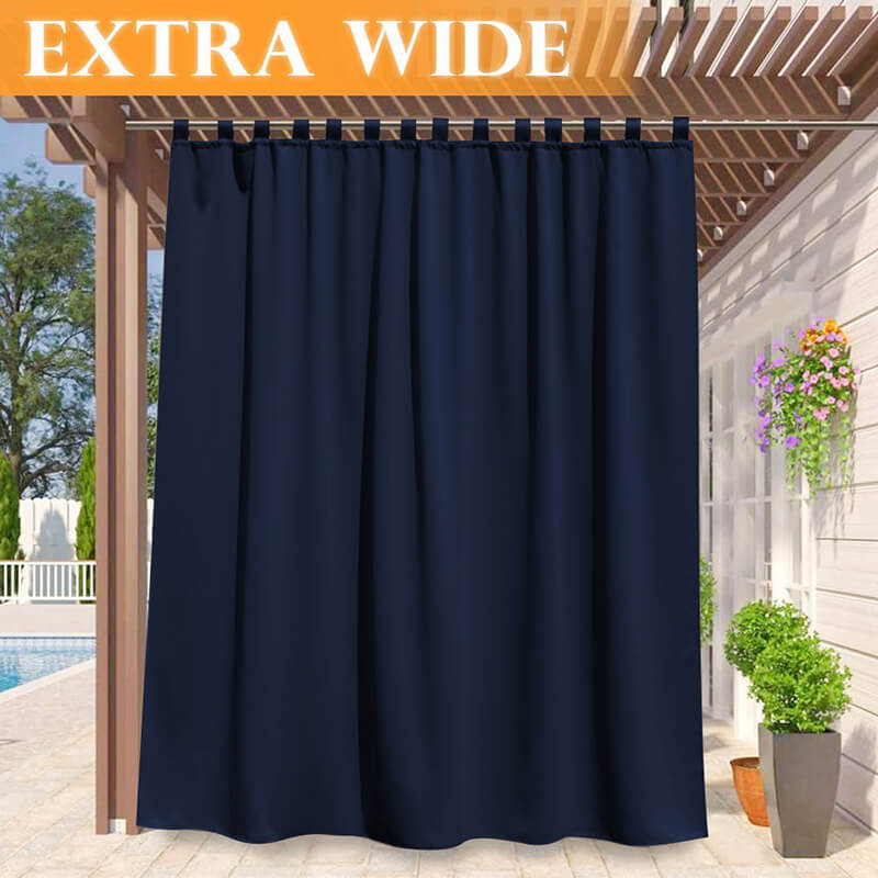 Dark blue extra wide waterproof tab top outdoor curtain on a patio pergola, providing privacy for a deck and pool area.